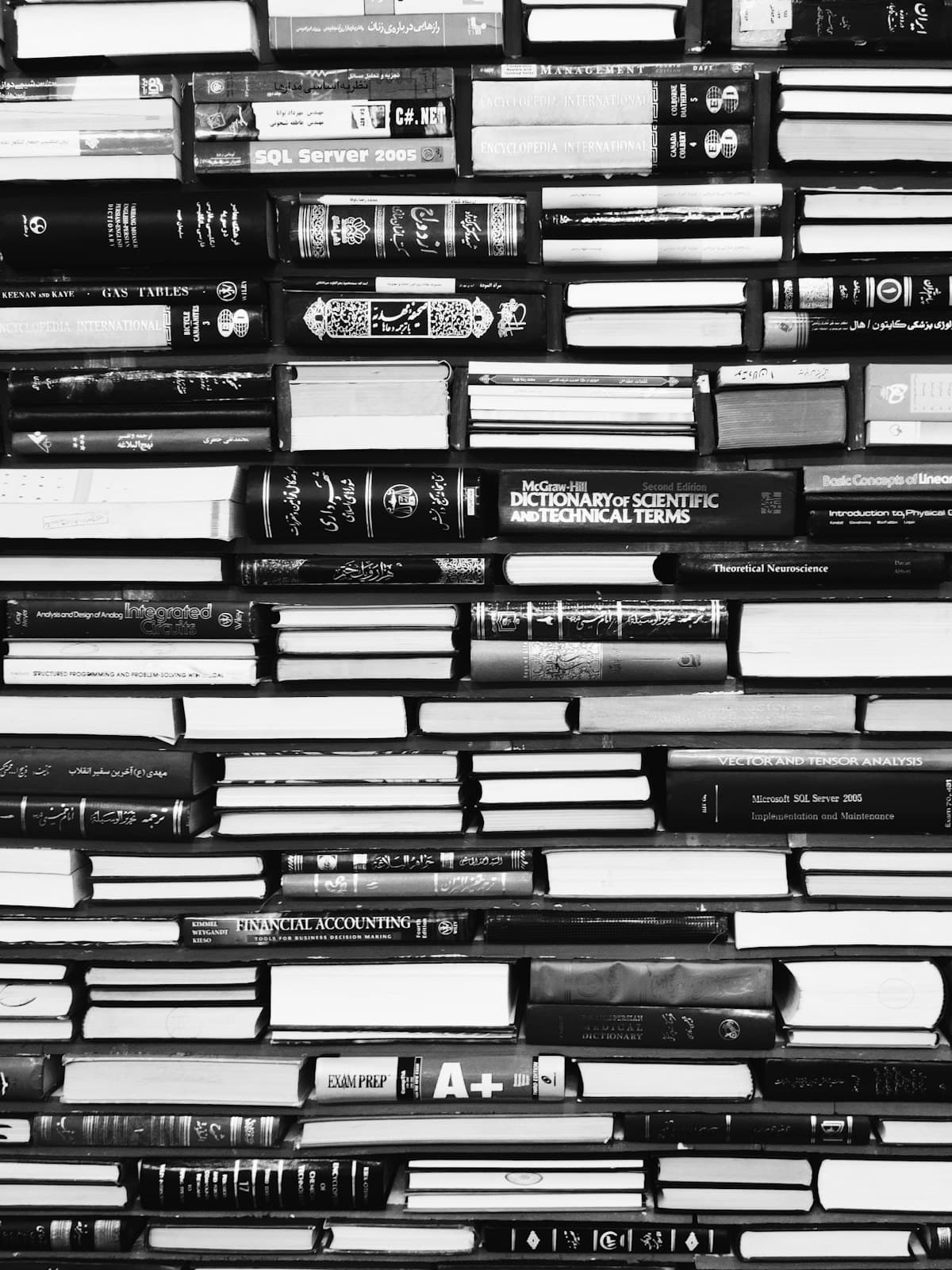 Densely stacked reference books seen edge on